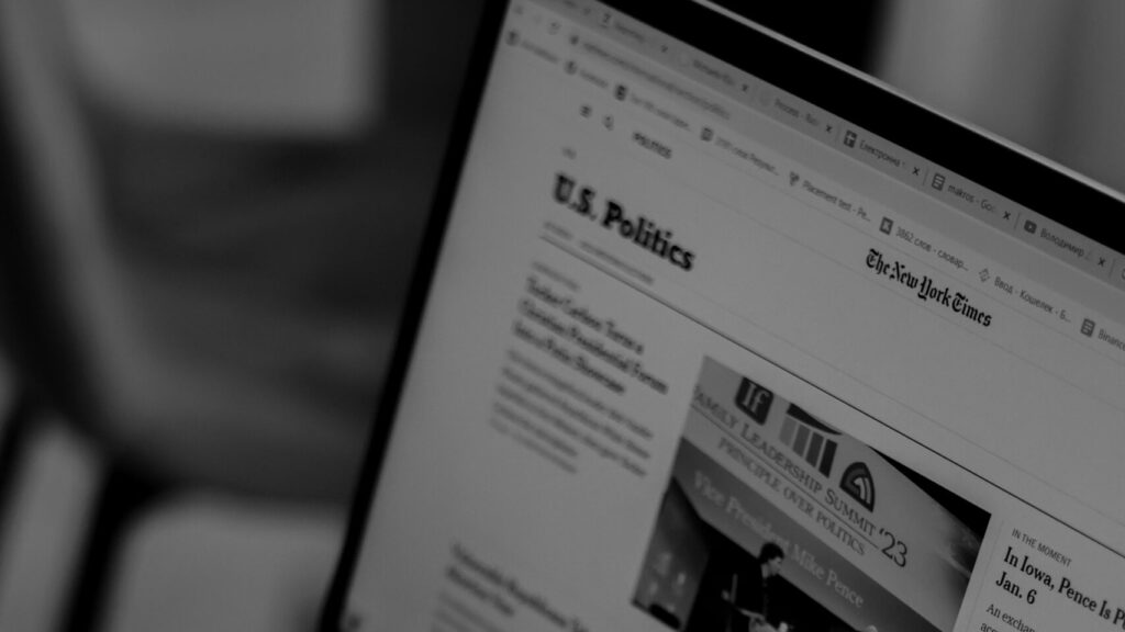 Laptop screen showing US Politics news webpage with headlines and articles.